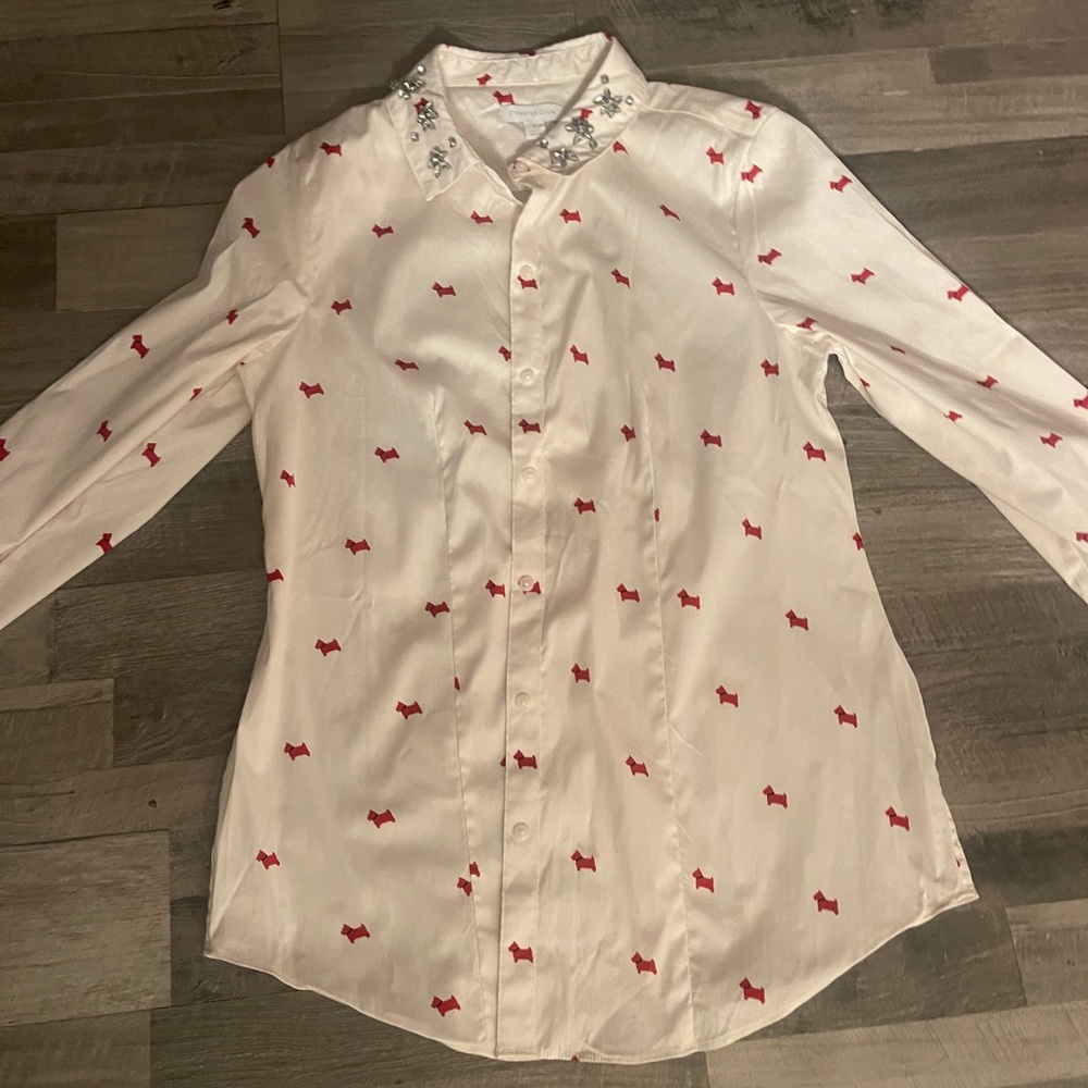off white blouse. sparkly bling on collar. red dogs